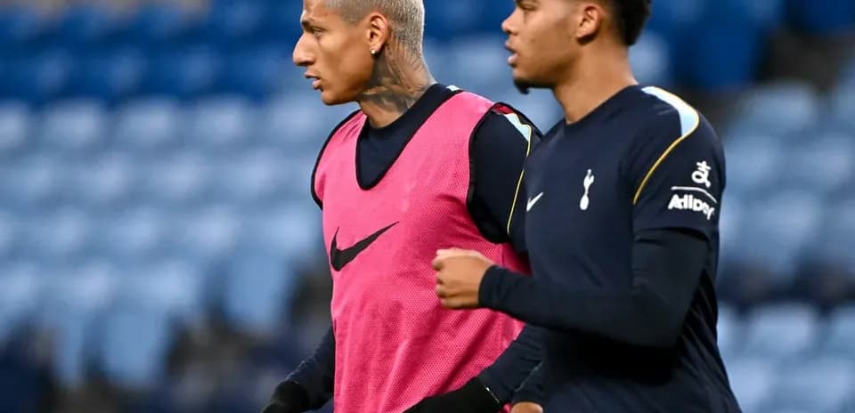 Two Tottenham players warming up on the pitch