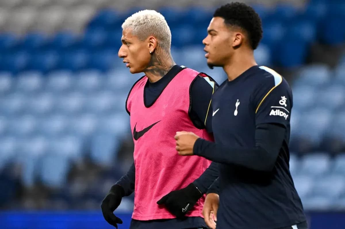 Two Tottenham players warming up on the pitch