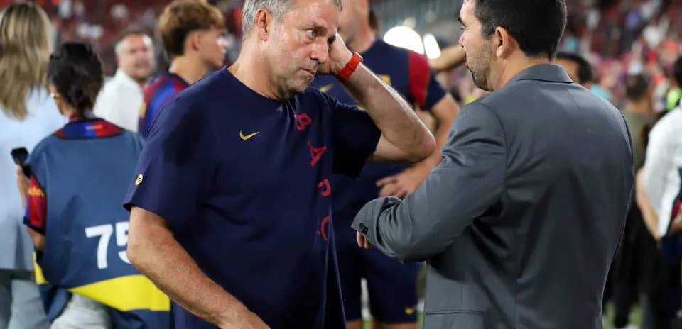 Coaches discussing after the match on the pitch