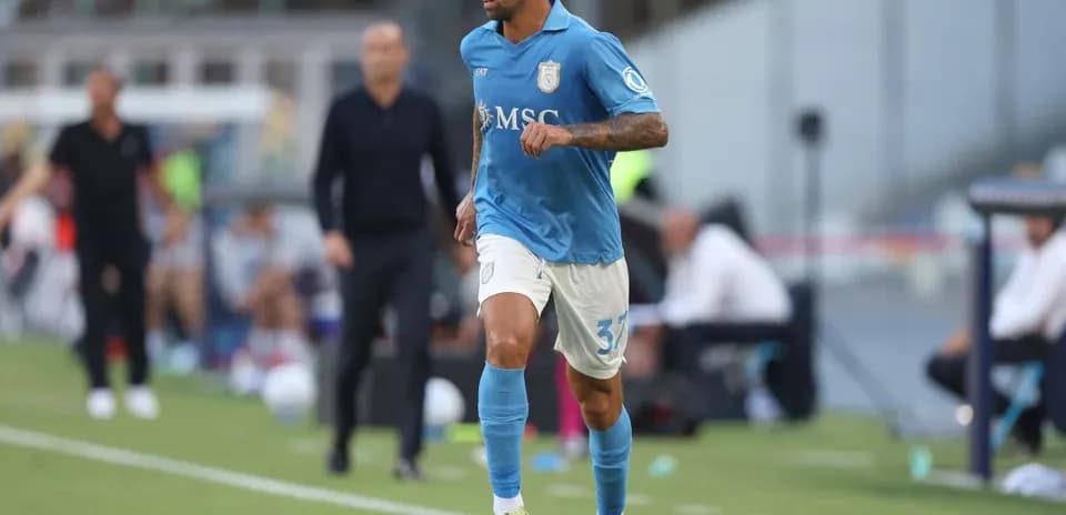 Player in blue kit dribbling the ball on field