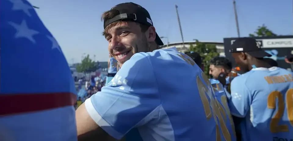 Player smiling at celebration event with teammates