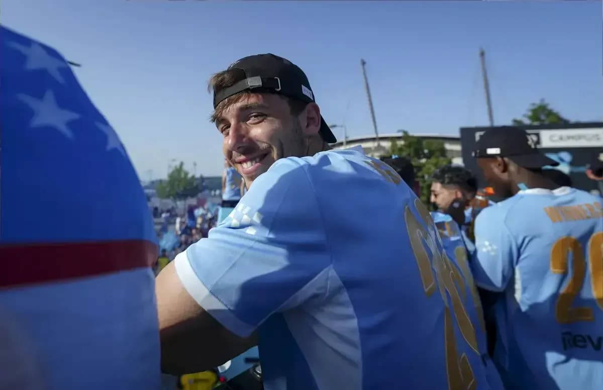 Player smiling at celebration event with teammates
