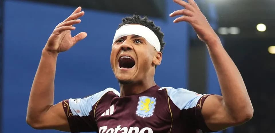 Player celebrating with bandage on head after goal