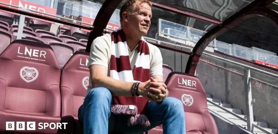 Man sitting on bench in football stadium