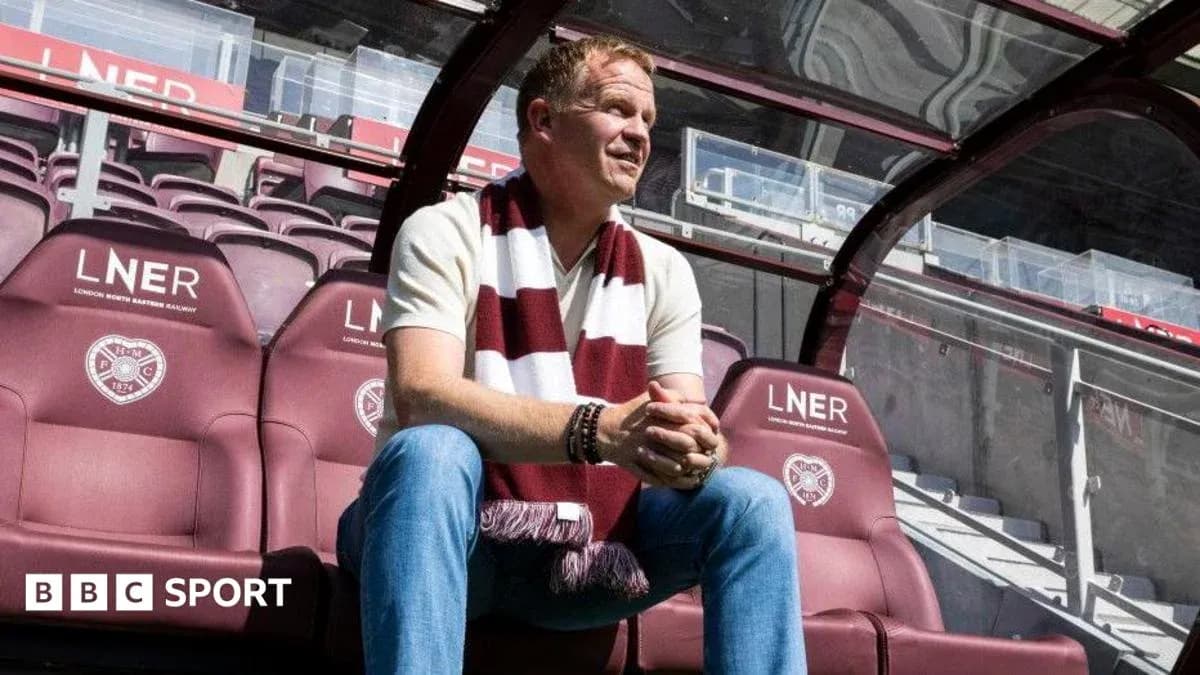 Man sitting on bench in football stadium