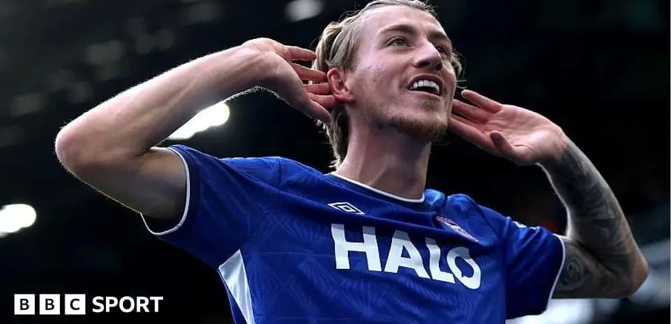 Player celebrating with hands to ears on field