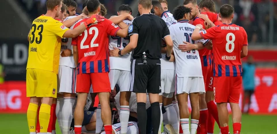 Players from both teams huddled during stoppage