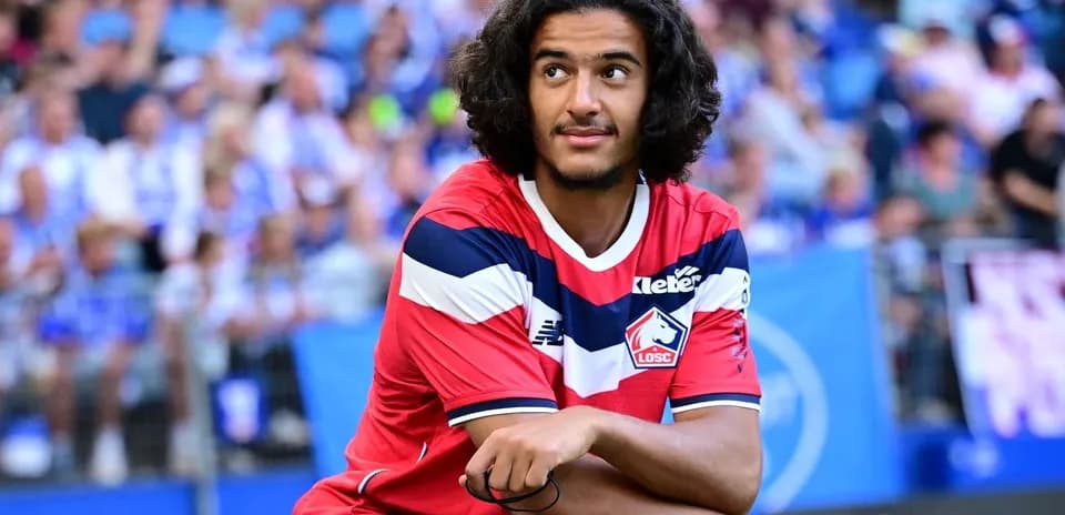 Player sitting on bench during match at stadium