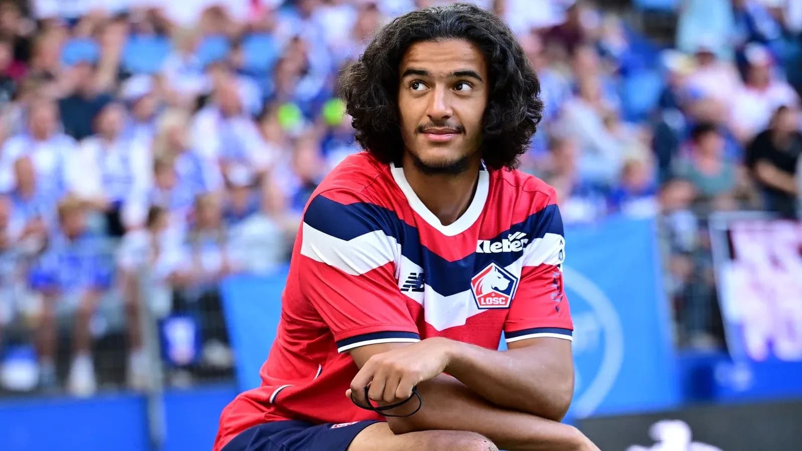 Player sitting on bench during match at stadium