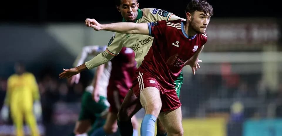 Two players contesting possession during a football match