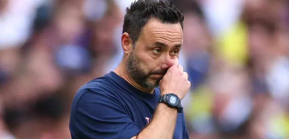 Coach observing match with hand on face