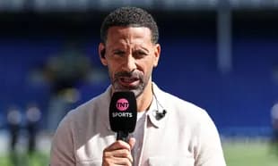 Presenter speaking into microphone on sports set