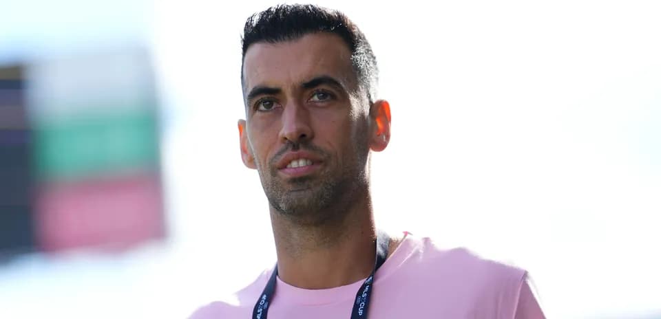 Player in a pink shirt at stadium entrance
