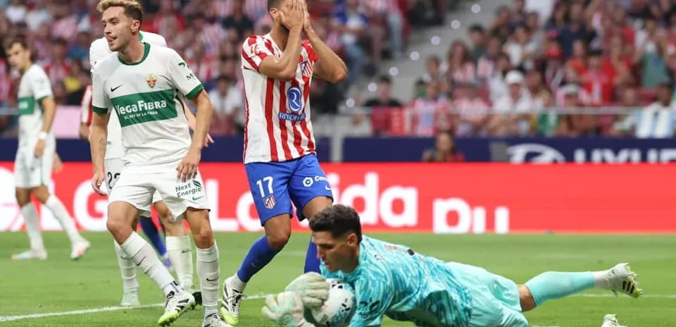 Elche player and Atletico Madrid goalkeeper in action