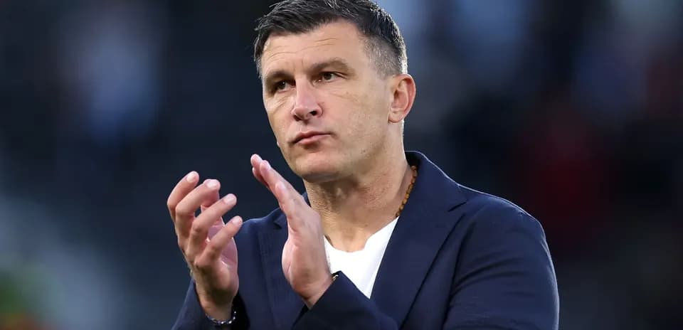 Coach applauding during a match on the sidelines