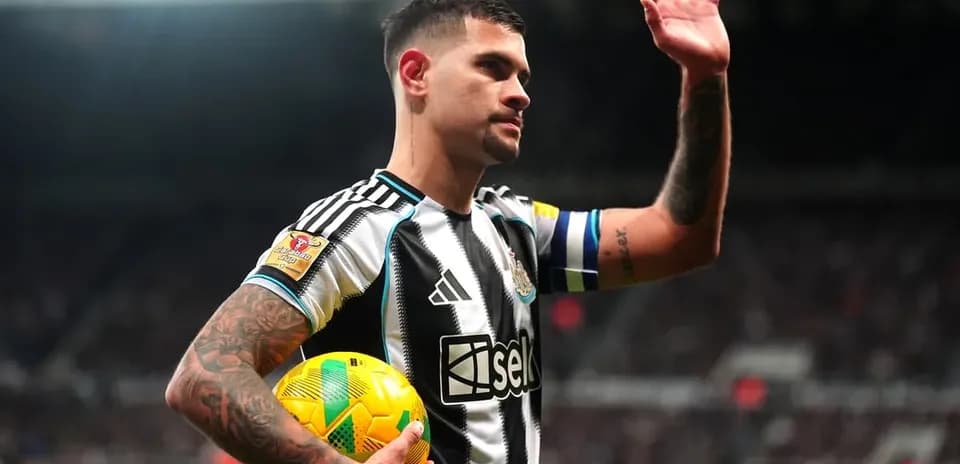 Player waving while holding a football during match