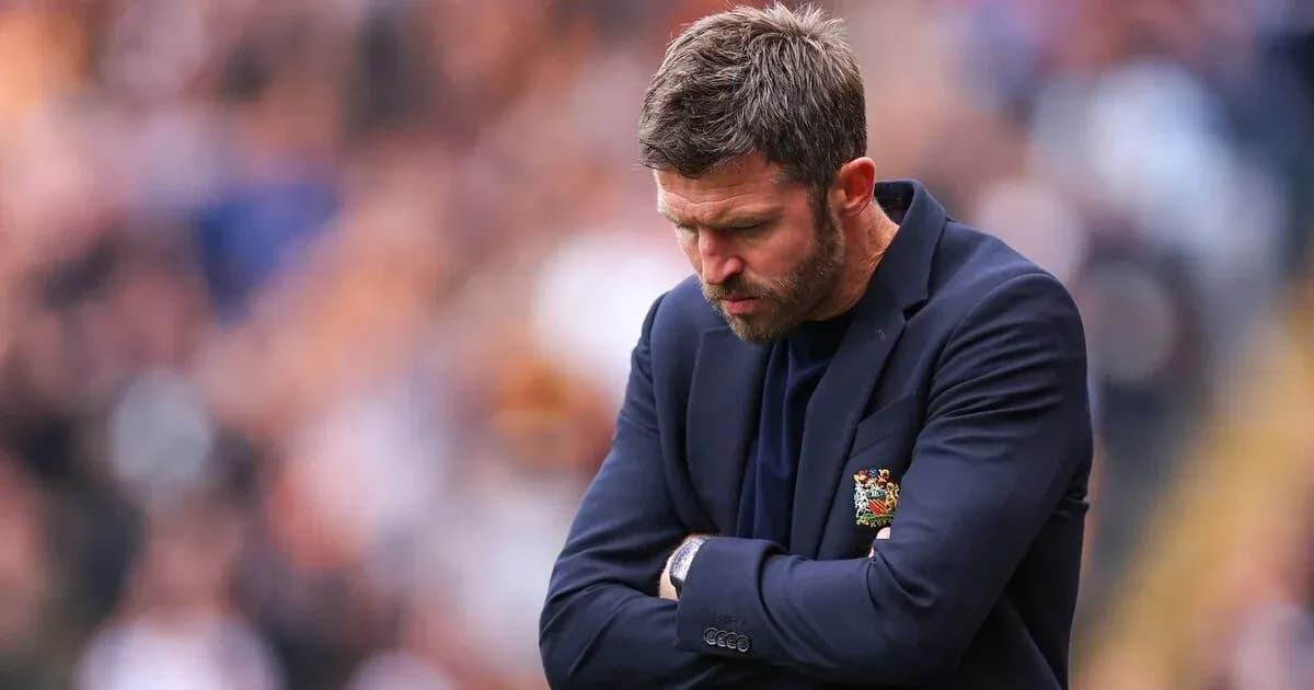 Coach with head down during match