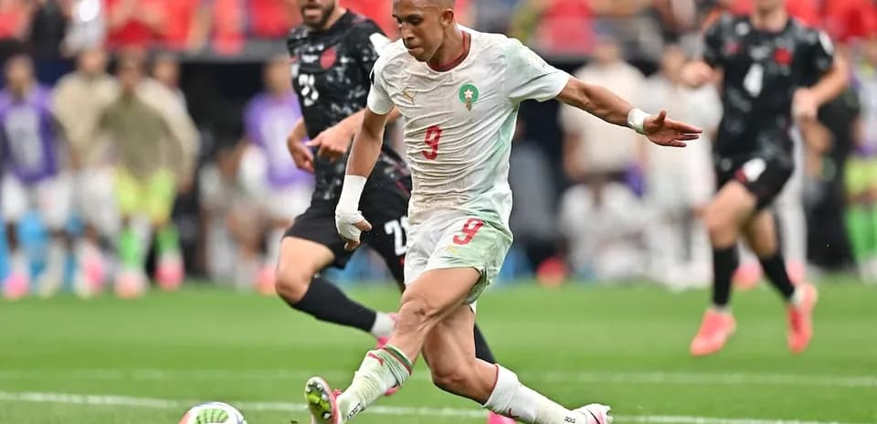 Moroccan player kicking the ball during match