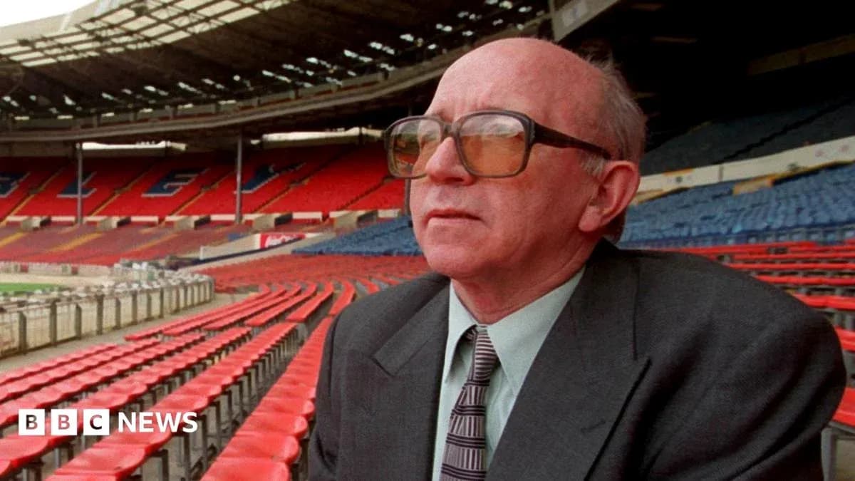 Person sitting in empty stadium stands, looking ahead