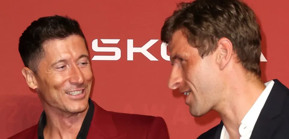 Two football players conversing at award event