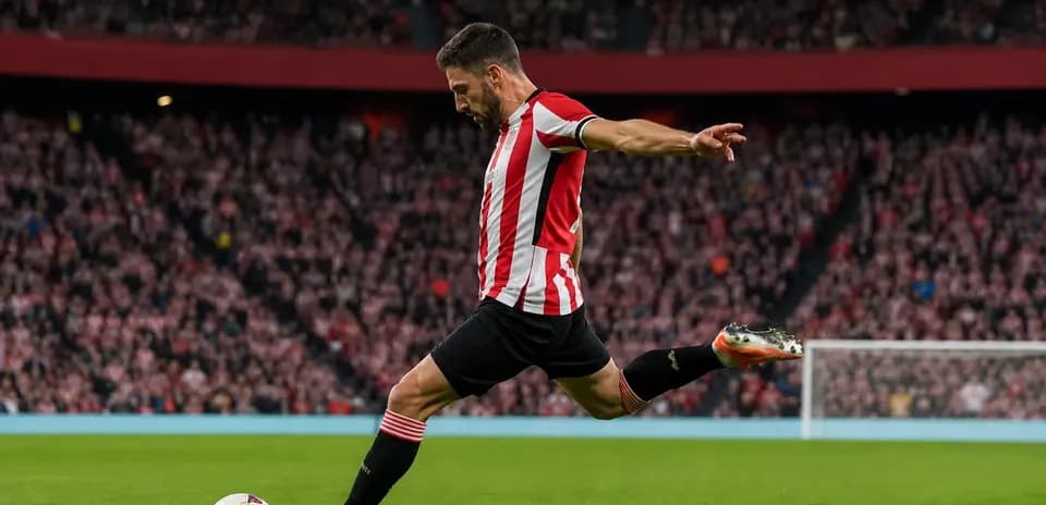 Player taking a free kick on the pitch