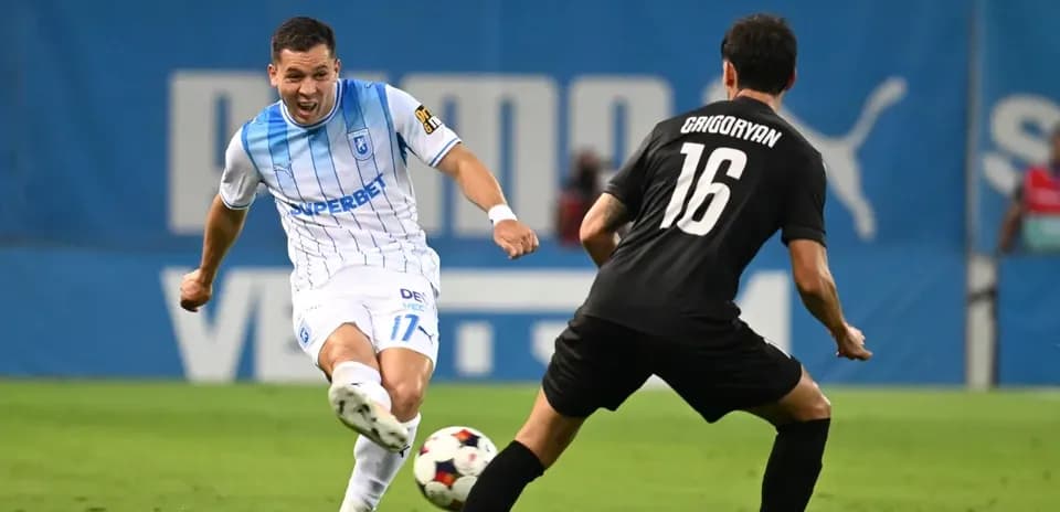 Universitatea Craiova player dribbling against defender