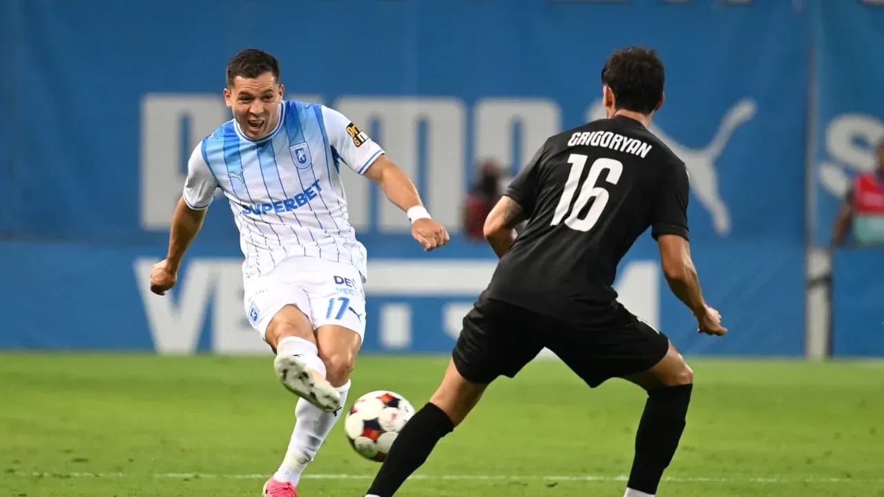 Universitatea Craiova player dribbling against defender
