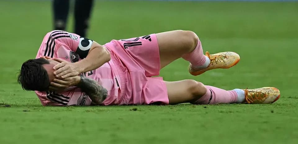 Player lying on ground, holding face in pain
