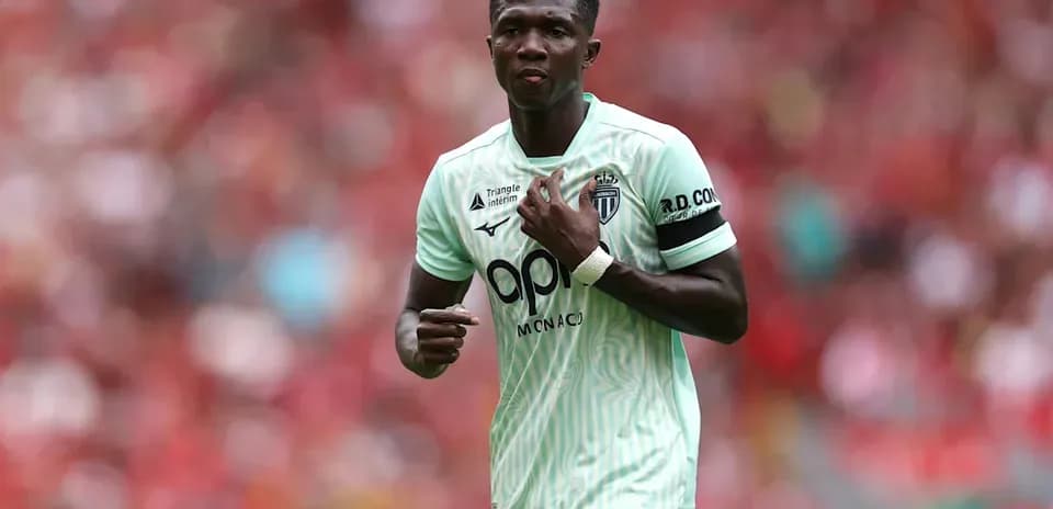 Player in green jersey during match at stadium