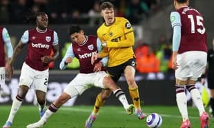 West Ham players tackling Wolves striker