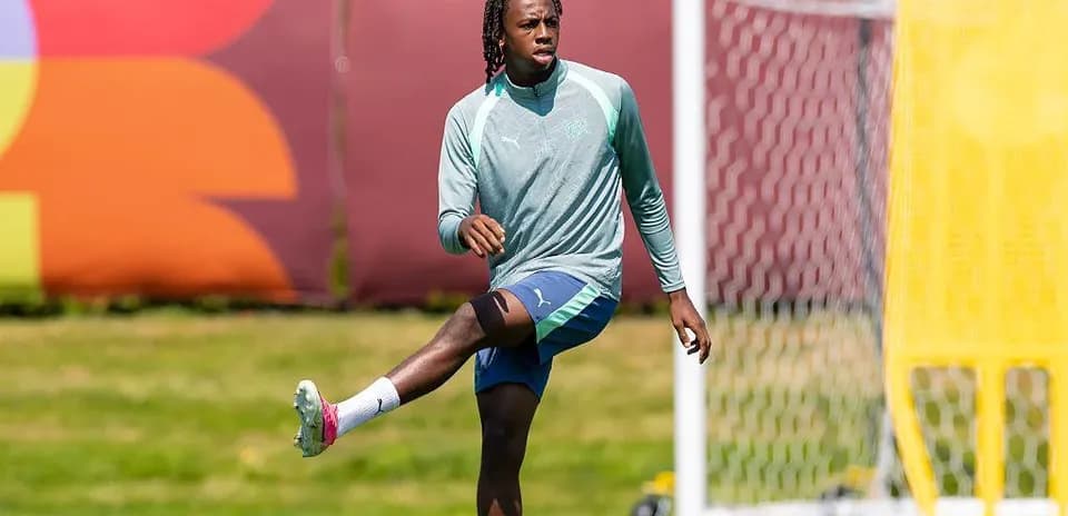 Player stretching during training session on pitch