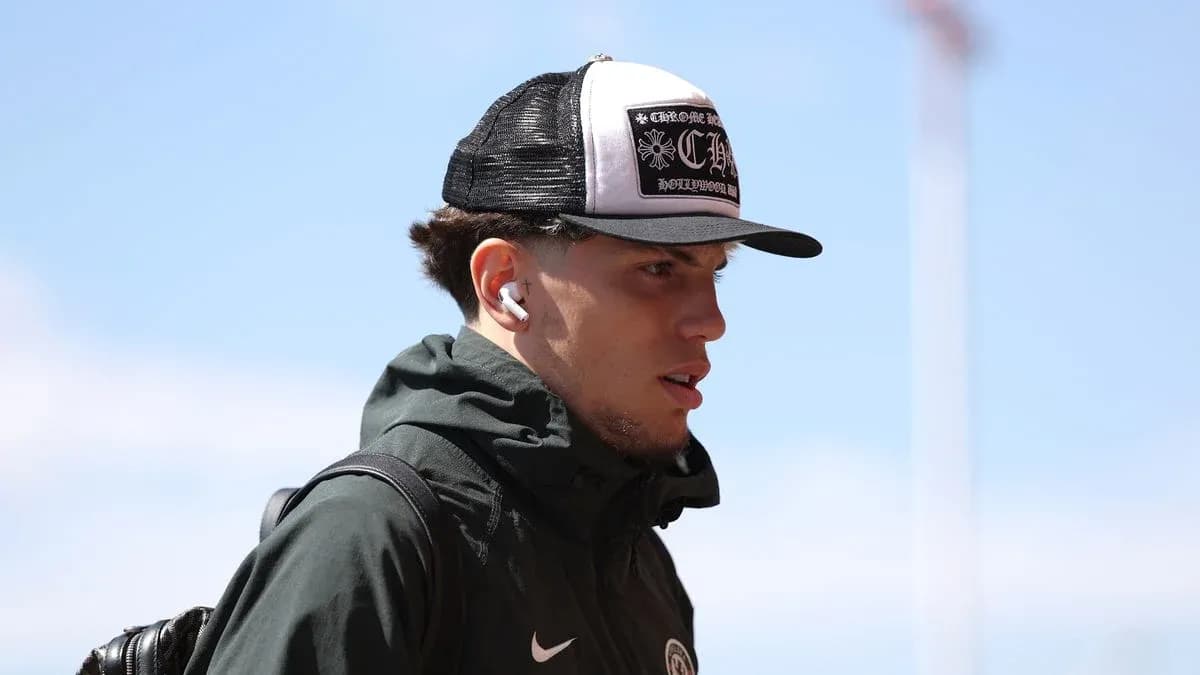 Player wearing a cap and earbuds walking outdoors