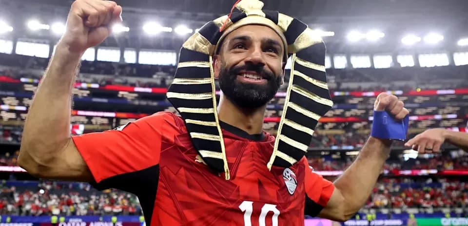 Player celebrating in Egyptian jersey and pharaoh headdress