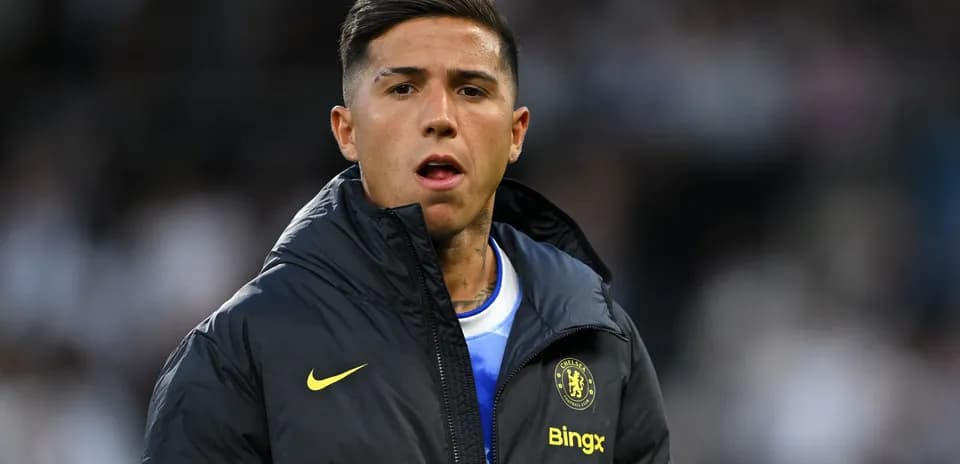 Player wearing Chelsea jacket on the sidelines