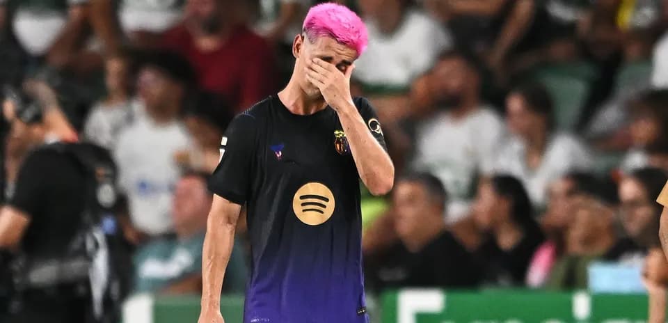 Player with pink hair walking off the pitch