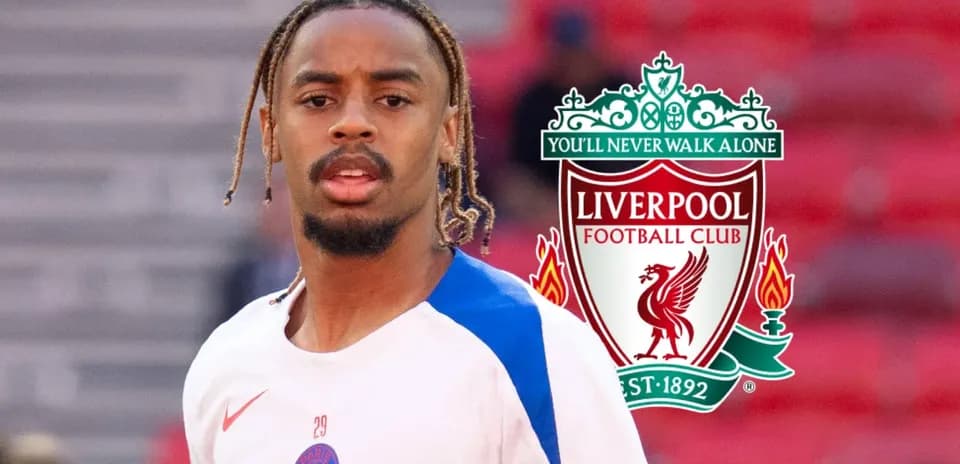 Player in training gear with Liverpool logo background