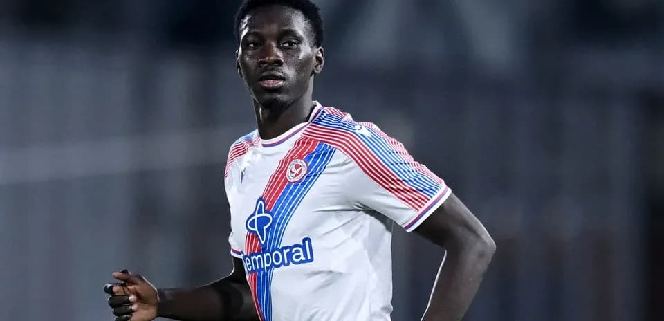 Player in white jersey running during match