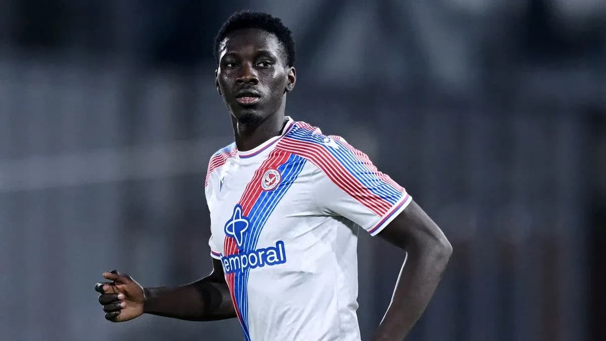 Player in white jersey running during match