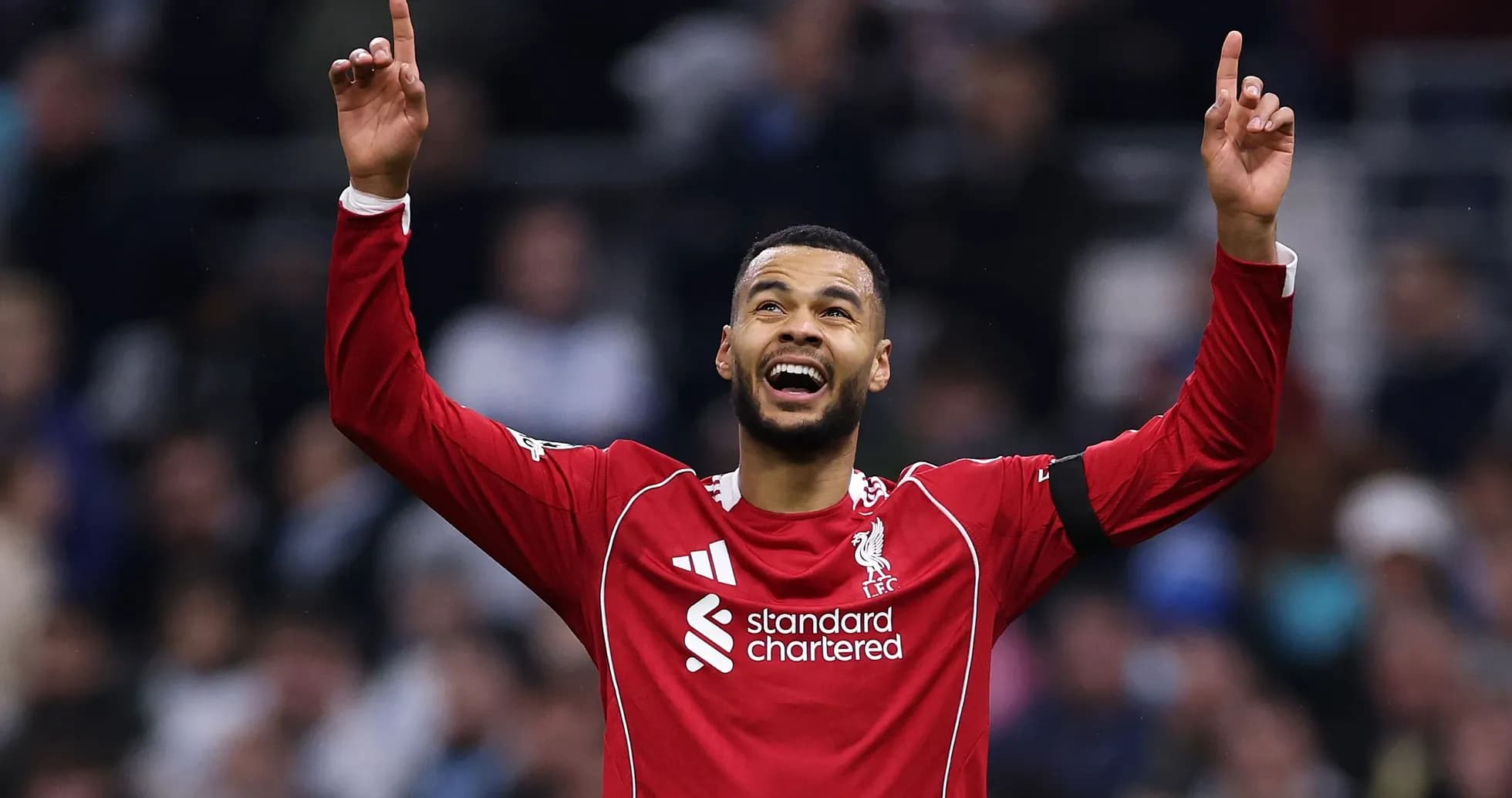 Player celebrating with arms raised after scoring