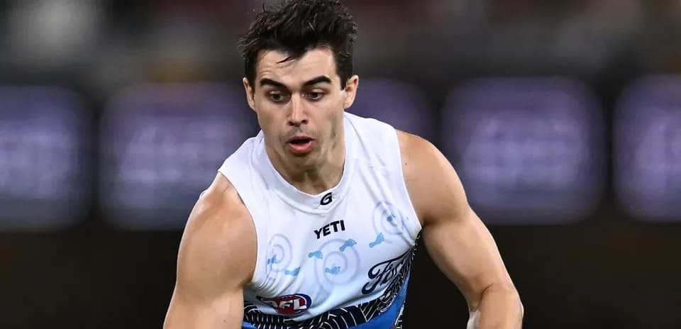 Player sprinting during an AFL match