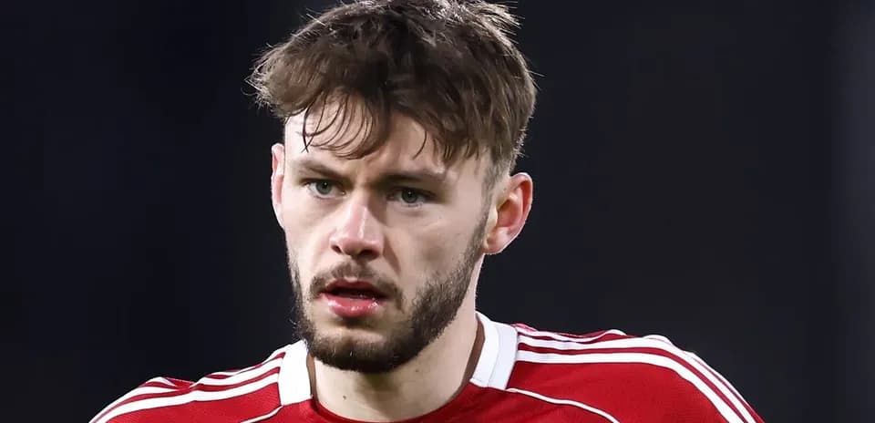 Player in red jersey looking focused during match