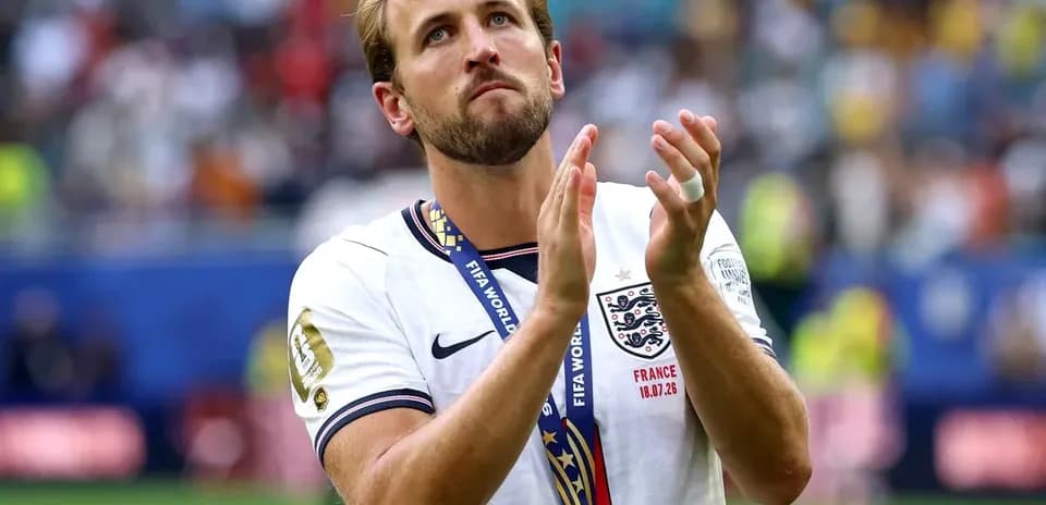 Player wearing medal, applauding after match