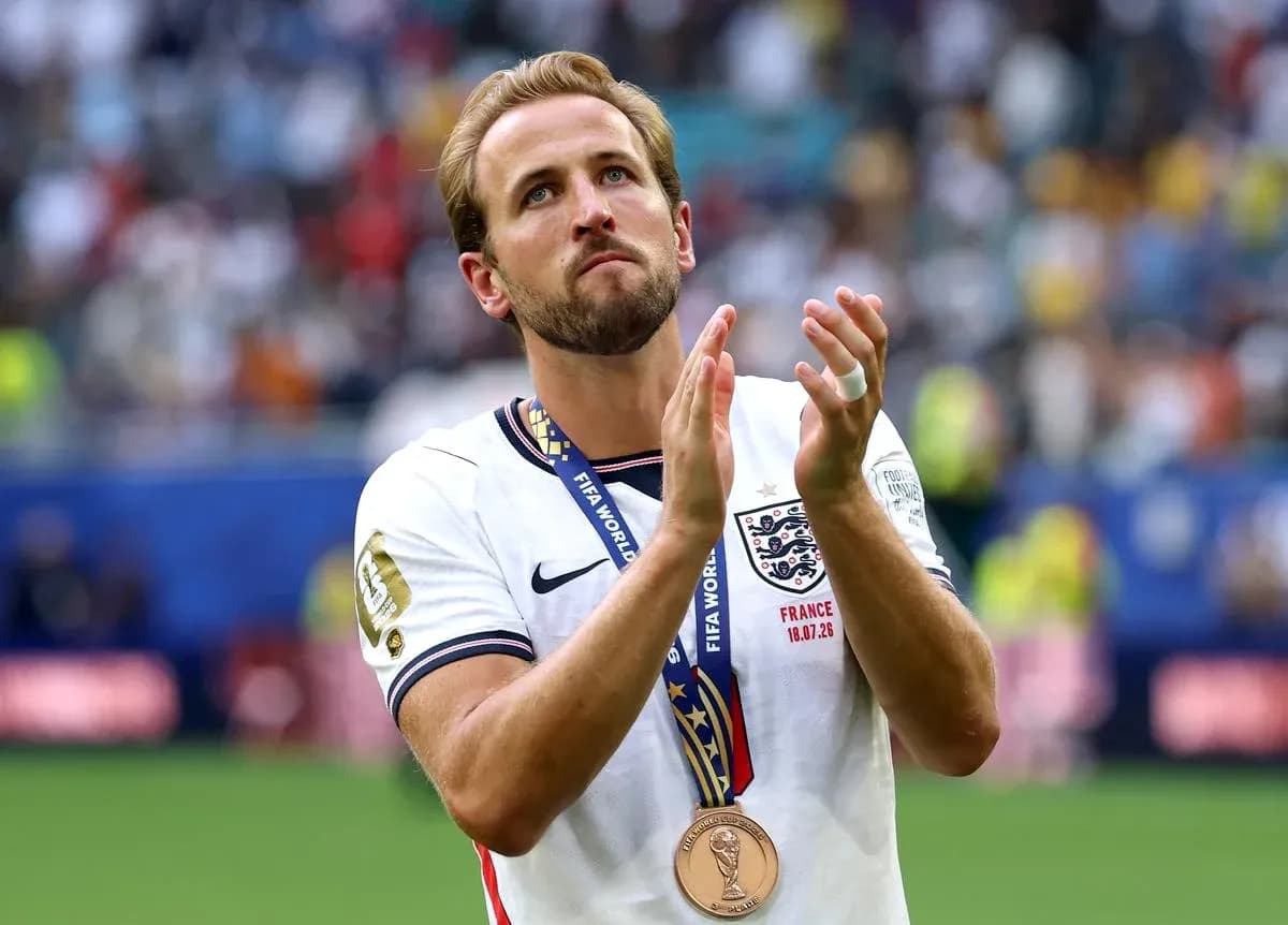Player wearing medal, applauding after match