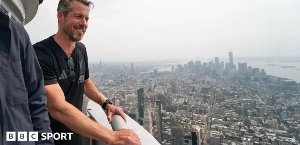 Person overlooking city skyline from tall building