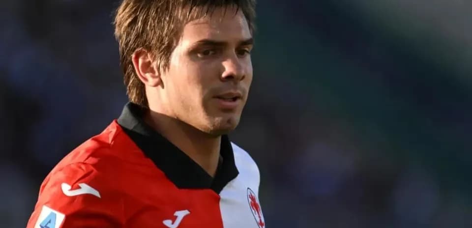 Player in red and white jersey during match