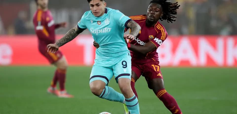Bologna player challenged by AS Roma opponent