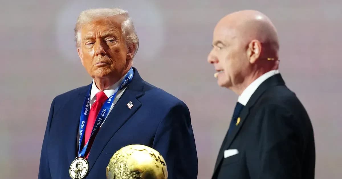 Two men at event holding FIFA prize trophy
