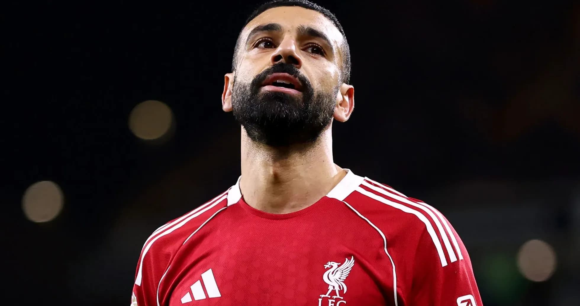 Player in red Liverpool jersey looking upwards