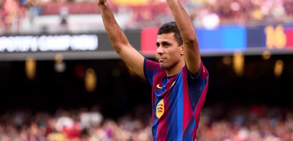 Player raising hands to fans at Camp Nou