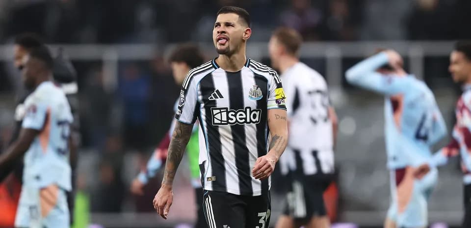 Newcastle player walking off after match defeat